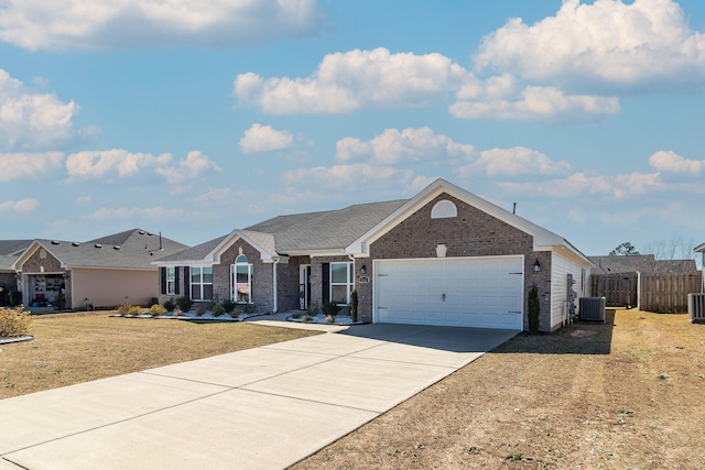 ranch-style home featuring an attached garage, brick siding, fence, concrete driveway, and a front yard