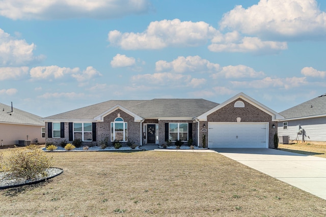 ranch-style home with a front yard, central AC, concrete driveway, and brick siding