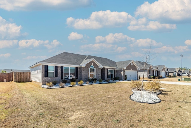 single story home with brick siding, an attached garage, a front yard, fence, and driveway