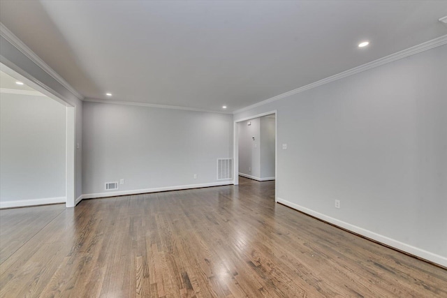 spare room featuring recessed lighting, wood finished floors, visible vents, and baseboards