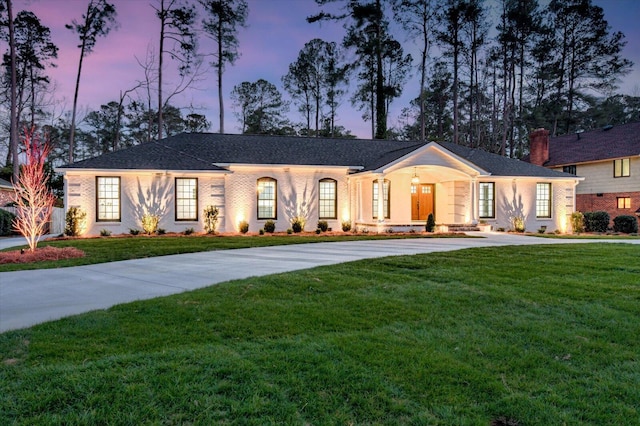 view of front of home featuring a front yard and concrete driveway