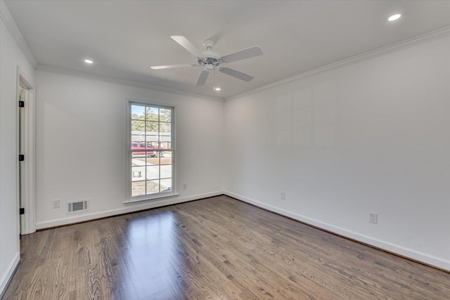 spare room with baseboards, visible vents, ceiling fan, ornamental molding, and wood finished floors