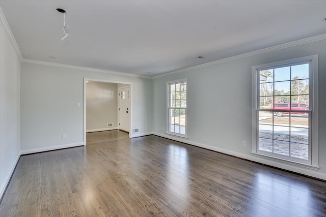 spare room with crown molding, dark wood finished floors, and baseboards