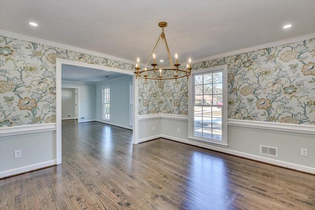 empty room with a wainscoted wall, visible vents, and wallpapered walls