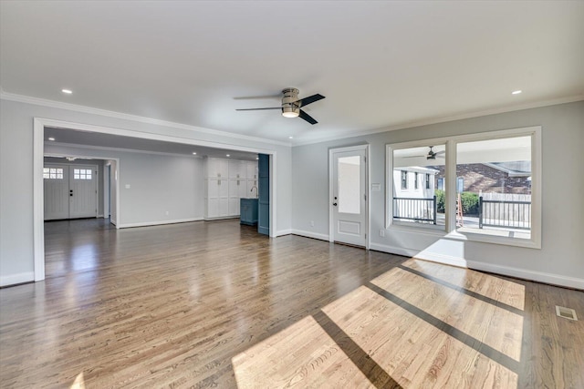 unfurnished living room with ceiling fan, crown molding, baseboards, and wood finished floors