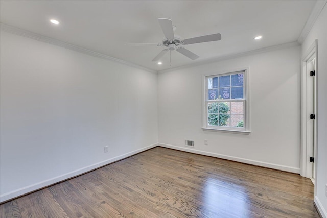 unfurnished room with ornamental molding, baseboards, and wood finished floors