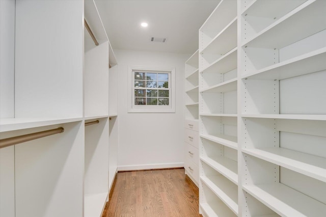 spacious closet featuring visible vents and wood finished floors