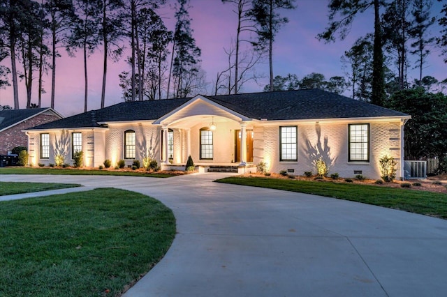 single story home featuring driveway, a front lawn, crawl space, and brick siding