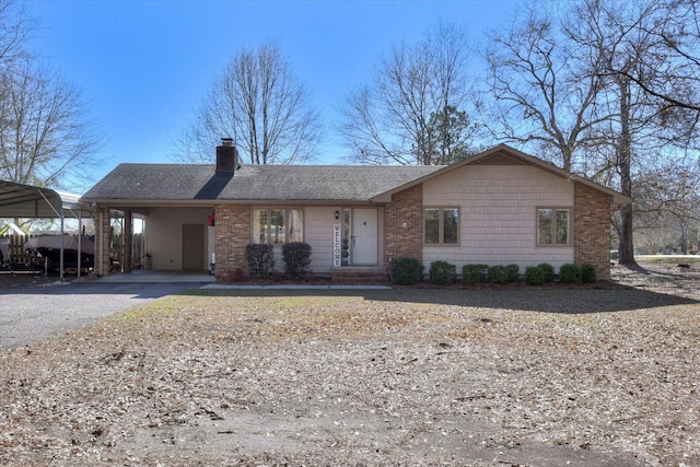 single story home featuring a carport