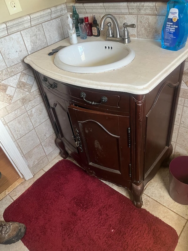 bathroom with vanity, tile walls, and stone tile flooring