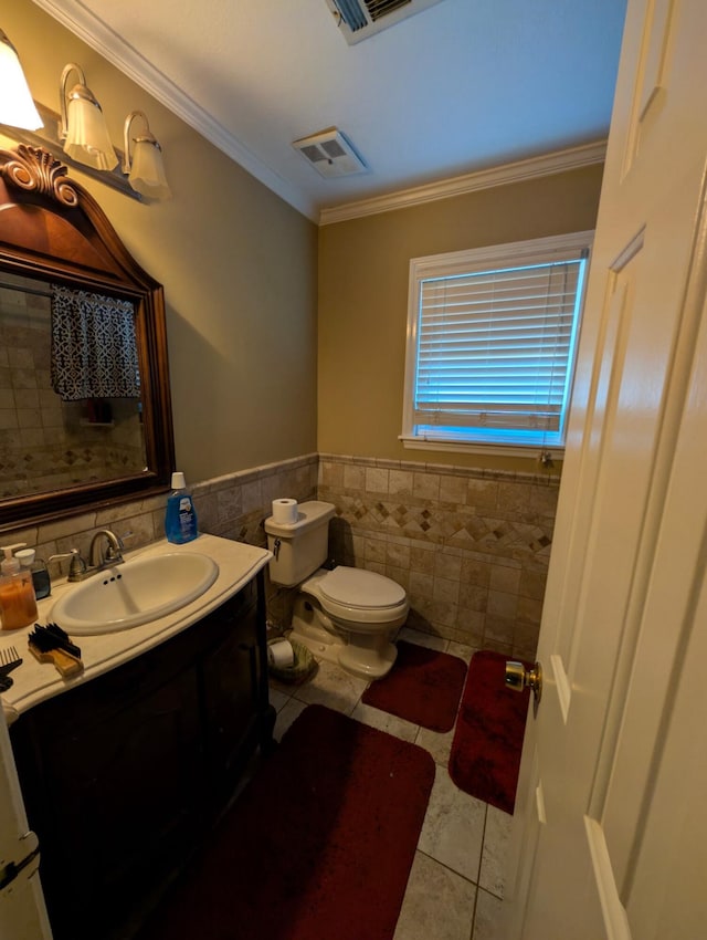 bathroom featuring tile patterned flooring, visible vents, crown molding, toilet, and vanity