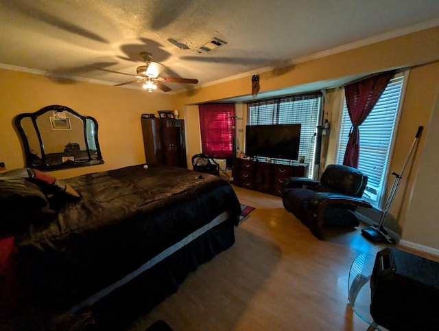 bedroom featuring wood finished floors, ceiling fan, and ornamental molding