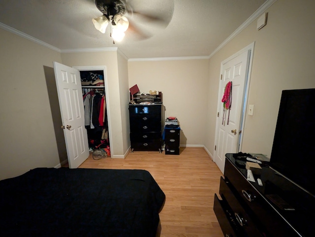 bedroom with light wood-style flooring, baseboards, and ornamental molding