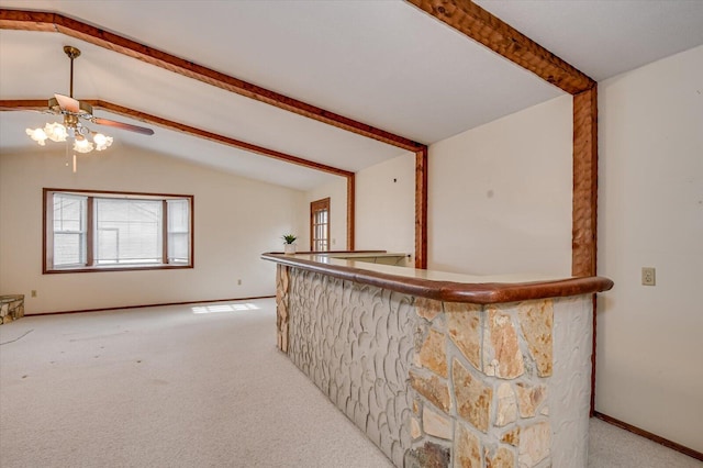 bar featuring baseboards, lofted ceiling with beams, carpet flooring, a bar, and a ceiling fan