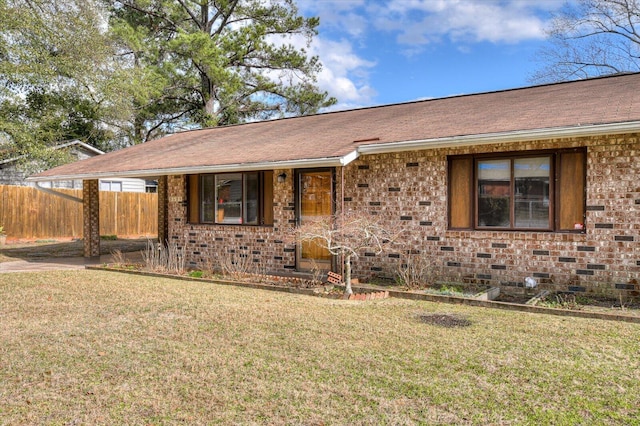 single story home featuring fence, roof with shingles, a front yard, crawl space, and brick siding