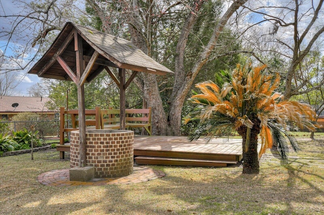 view of yard with a deck and fence