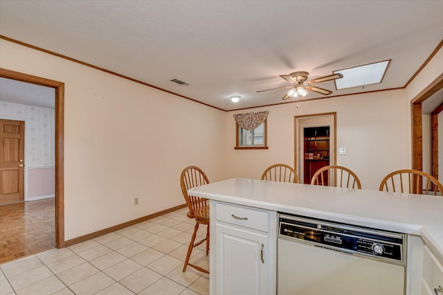 kitchen with visible vents, a kitchen breakfast bar, white cabinets, crown molding, and dishwasher