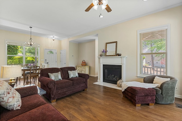 9 Caravel Cir, Mccormick, SC 29835 - living area featuring wood finished floors, ceiling fan, ornamental molding, a fireplace with flush hearth, and a chandelier