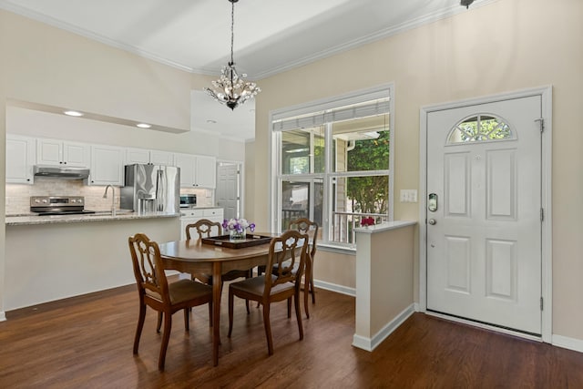 9 Caravel Cir, Mccormick, SC 29835 - dining area featuring a chandelier, ornamental molding, dark wood-style flooring, and baseboards