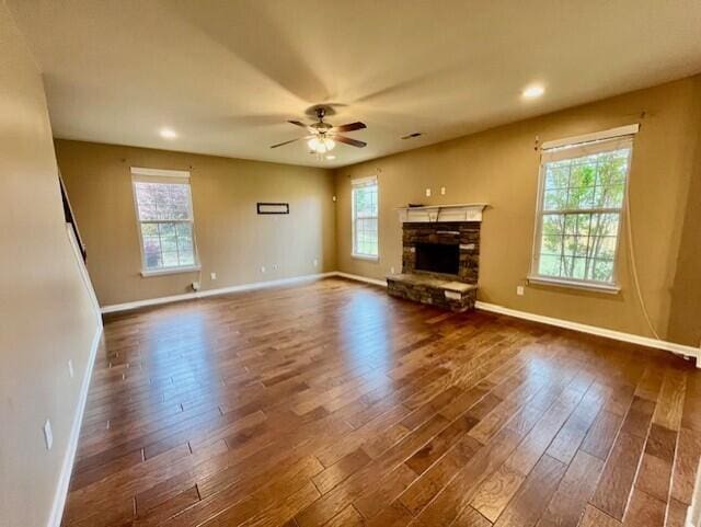 603 Yonto Dr, Grovetown, GA 30813 - unfurnished living room with baseboards, dark wood-style floors, a ceiling fan, a stone fireplace, and recessed lighting