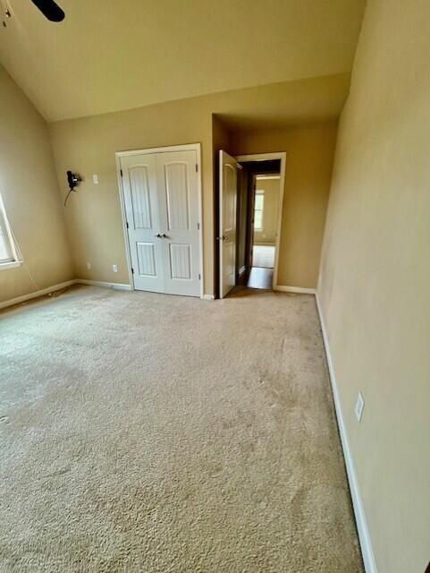603 Yonto Dr, Grovetown, GA 30813 - unfurnished bedroom with a closet, baseboards, carpet, lofted ceiling, and a ceiling fan