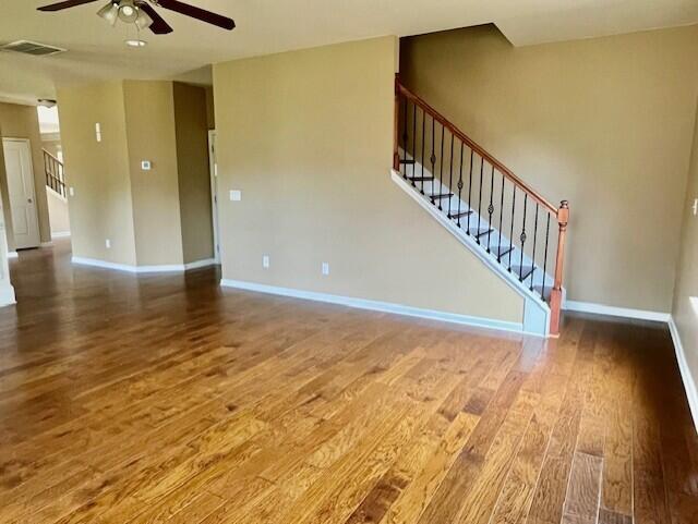603 Yonto Dr, Grovetown, GA 30813 - unfurnished living room with a ceiling fan, wood finished floors, stairway, and baseboards