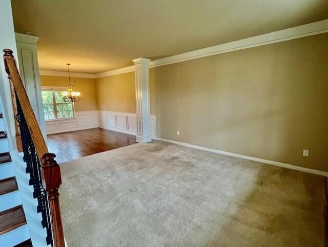 603 Yonto Dr, Grovetown, GA 30813 - spare room featuring carpet, crown molding, a chandelier, decorative columns, and wainscoting