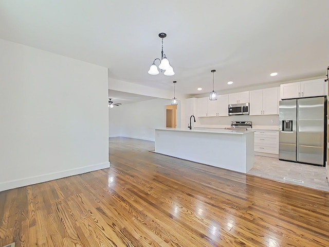 1904 Robin Rd, North Augusta, SC 29841 - kitchen featuring appliances with stainless steel finishes, a chandelier, light wood-style flooring, recessed lighting, and open floor plan