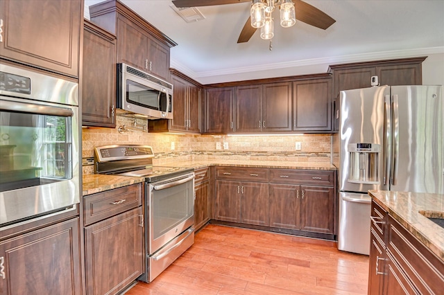 474 Sebastian Dr, Grovetown, GA 30813 - kitchen with appliances with stainless steel finishes, crown molding, a ceiling fan, light wood-style flooring, and light stone countertops