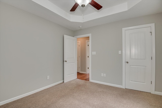 474 Sebastian Dr, Grovetown, GA 30813 - unfurnished bedroom with carpet, a tray ceiling, and ceiling fan