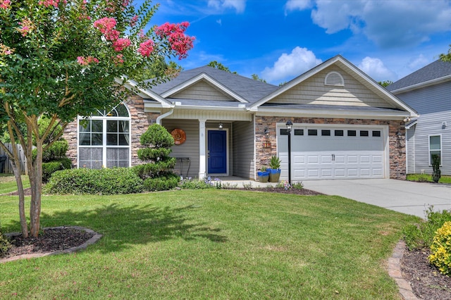 474 Sebastian Dr, Grovetown, GA 30813 - view of front of home featuring stone siding, an attached garage, driveway, a front lawn, and covered porch