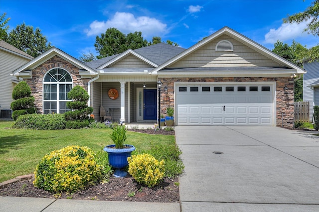 474 Sebastian Dr, Grovetown, GA 30813 - view of front facade with a front yard, driveway, a garage, stone siding, and a porch