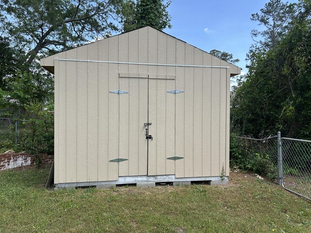 view of shed with fence