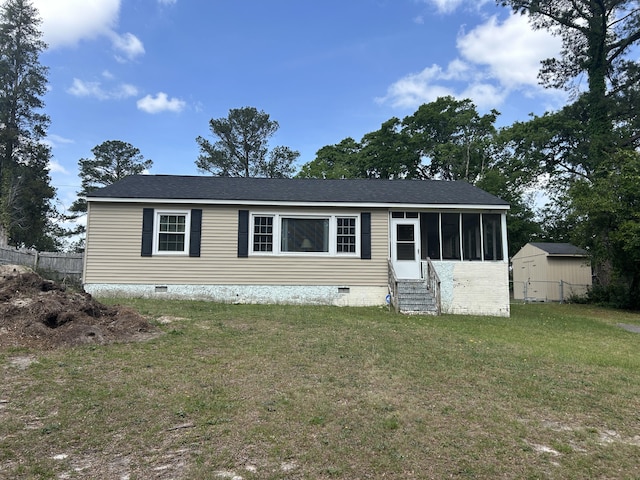 manufactured / mobile home featuring a sunroom, a front lawn, crawl space, entry steps, and fence