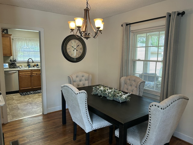 dining space with a chandelier, baseboards, and wood finished floors