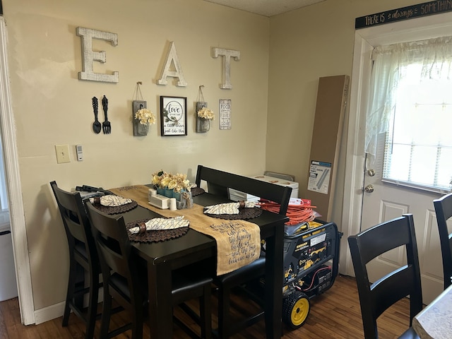 dining room featuring wood finished floors and baseboards