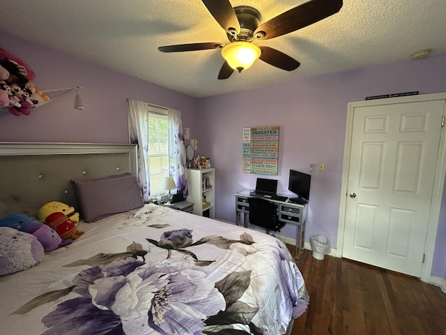 bedroom with a textured ceiling, wood finished floors, ceiling fan, and baseboards