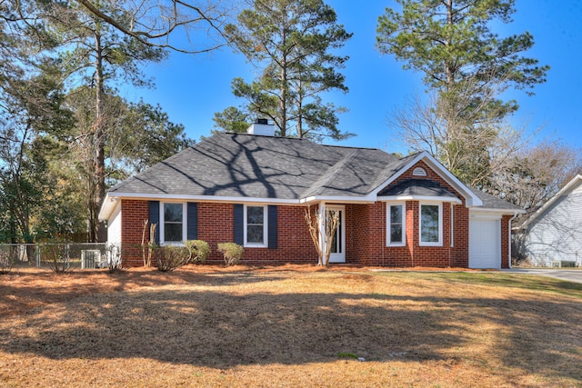 ranch-style home featuring a front yard, fence, an attached garage, a chimney, and brick siding