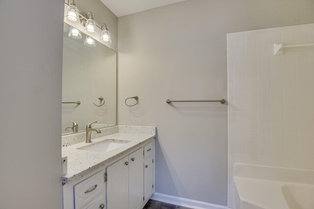 bathroom featuring baseboards and vanity