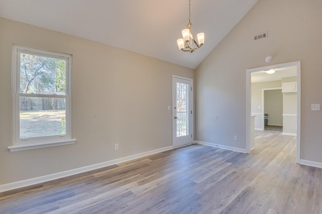 unfurnished room featuring visible vents, baseboards, an inviting chandelier, and light wood-style flooring