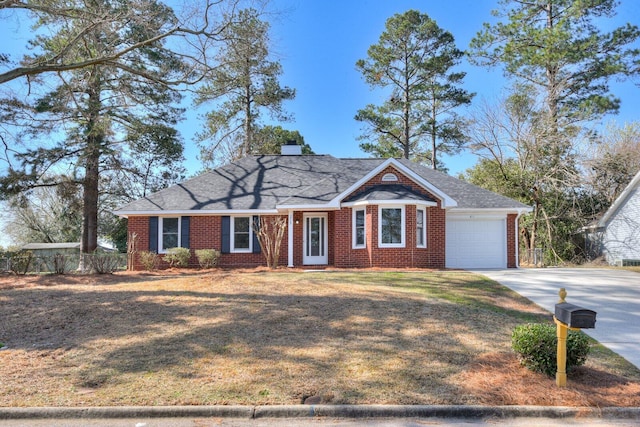 ranch-style house featuring driveway, a front yard, a garage, brick siding, and a chimney