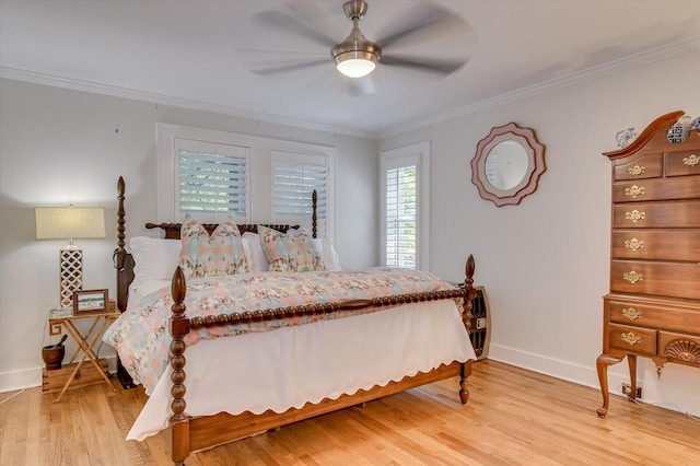 bedroom with crown molding, baseboards, and wood finished floors