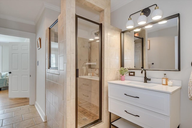 bathroom with a stall shower, tile patterned floors, vanity, and crown molding