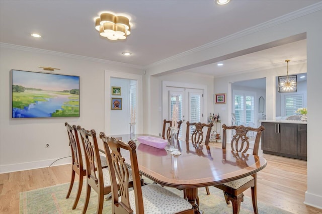 dining area with recessed lighting, baseboards, french doors, light wood finished floors, and crown molding