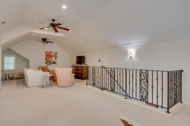 living area with lofted ceiling, carpet flooring, visible vents, an upstairs landing, and ornamental molding