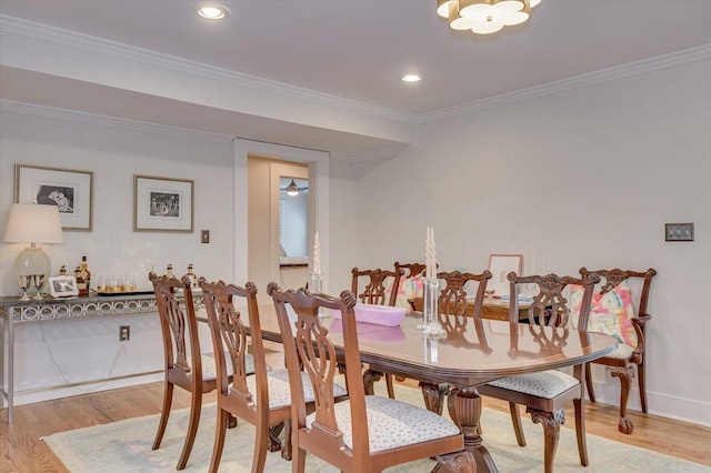 dining room with baseboards, ornamental molding, recessed lighting, and light wood-style floors