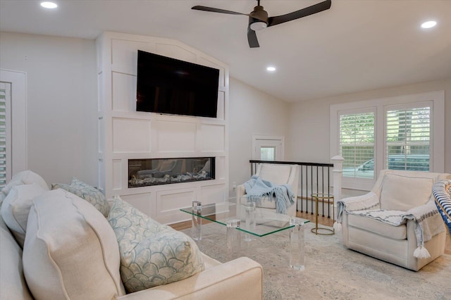 living area featuring ceiling fan, vaulted ceiling, wood finished floors, and recessed lighting