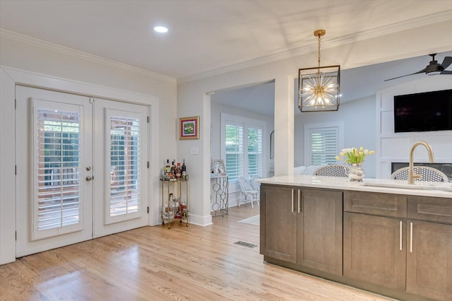 kitchen featuring french doors, visible vents, crown molding, and light wood finished floors