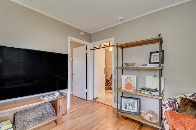 interior space with ornamental molding and wood finished floors