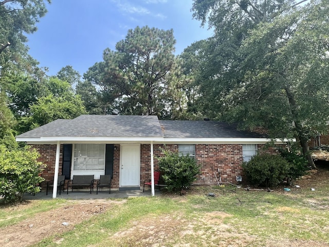 3407 Charing Cross Ct, Augusta, GA 30906 - ranch-style house with a porch, a front lawn, brick siding, and a shingled roof